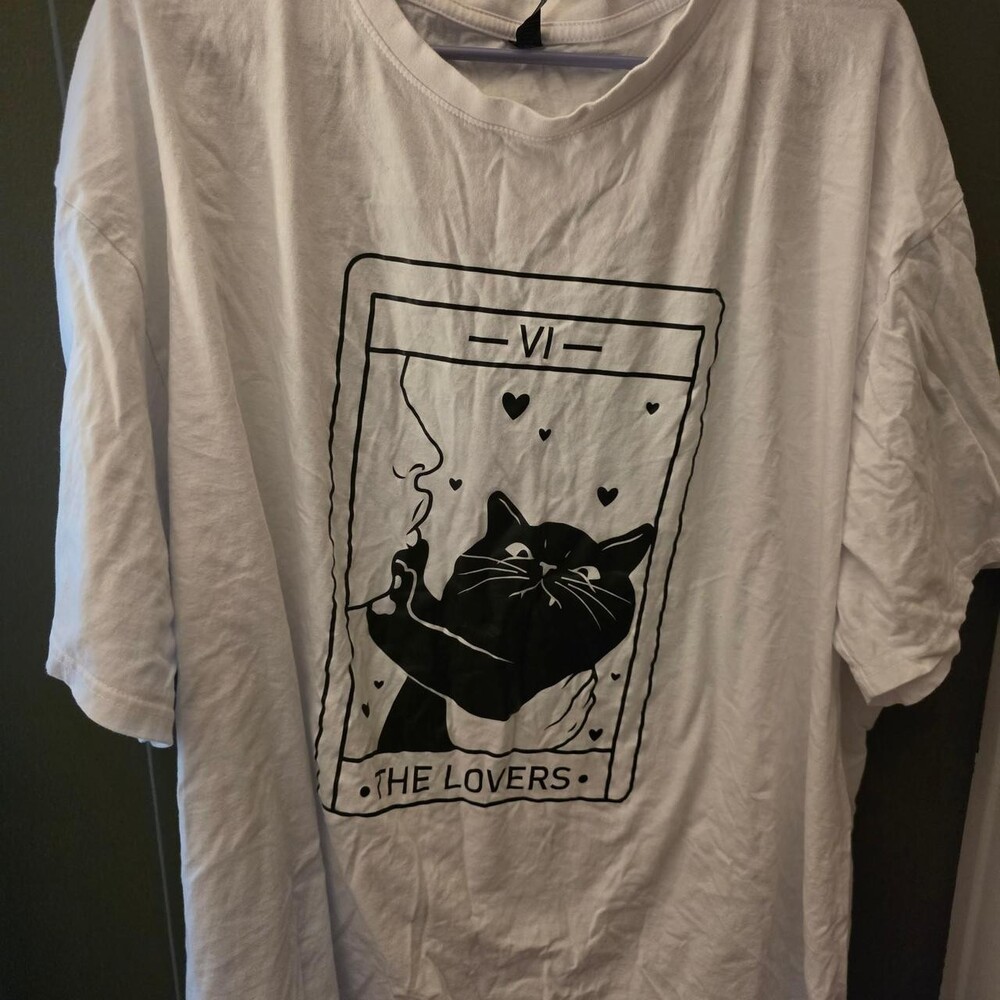 White/black cat tarot tee with black graphic of a cat holding a cigarette with h